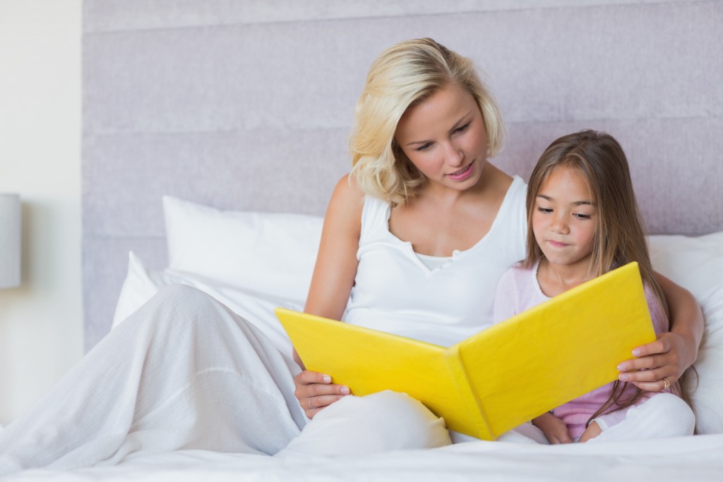 Mother reading a book with her daughter