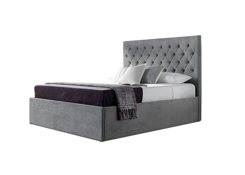 grey upholstered bed with pillows and throws